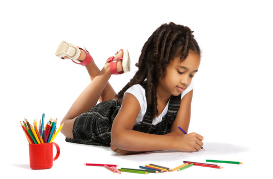 cheerful girl draws pencil lying on the floor