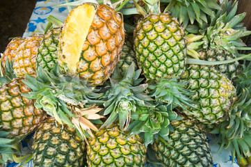 Stack of ripe many pineapples on the market