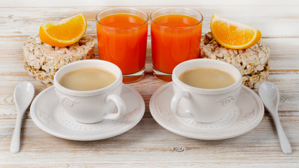 Obraz na płótnie Canvas Healthy breakfast with two coffee cup and orange juice