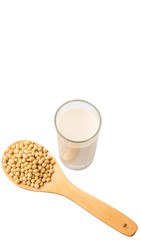 Soybean in a white bowl and a glass of soybean milk over white 