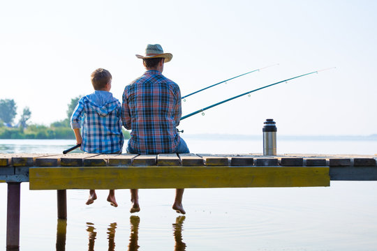 Boy And His Father Fishing Togethe