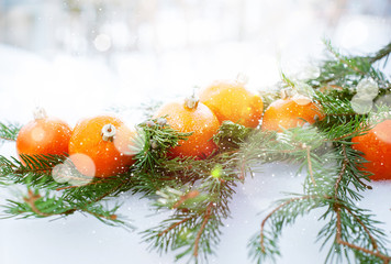 Fototapeta na wymiar Greeting Card with Tangerines, boke and snowflakes