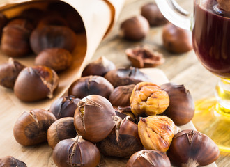Delicious roasted chestnuts on wooden board