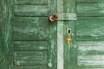 Old worn green wooden door