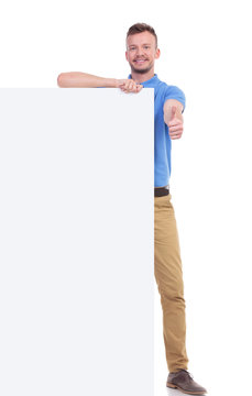 casual young man with pannel shows thumb up