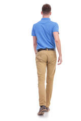 casual young man walks away from camera