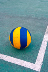 Old volleyball on a dirty court