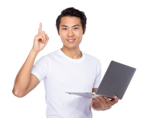 Asian man use of notebook computer and finger up