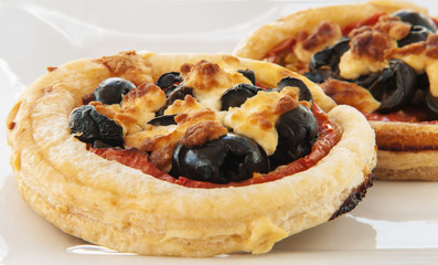 Close up of mini pizzas in white background