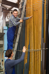 Two workers choosing PVC window profile