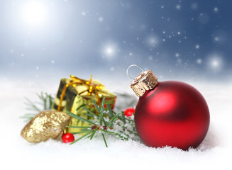 Fototapeta na wymiar Christmas background with red ornament in snow
