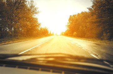 Autumn road at sunset