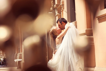 Happy bride and groom walking in the city of Sicily