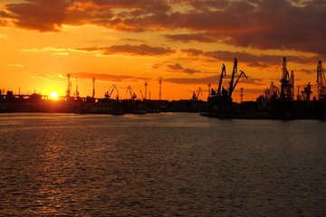 Fototapeta na wymiar Bright Colorful Sunset at Cargo Sea Port