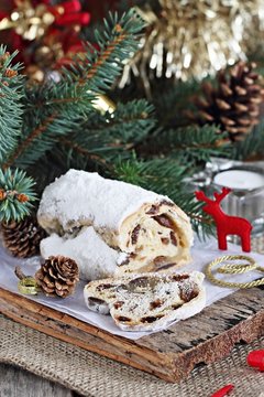 Traditional German Christmas cake ( Stollen ) on a wooden table