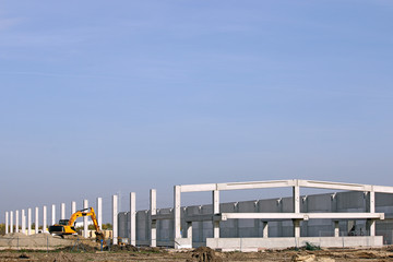 new factory construction site with excavator