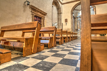 Fototapeta na wymiar Row of pews in Santa Maria church in Alghero
