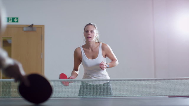 Young pretty woman playing table tennis
