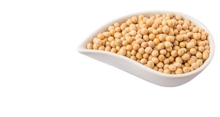 Soybean in an oval ceramic bowl over white background