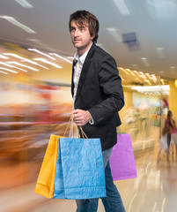 Handsome young man with shopping bags