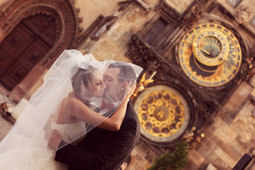 Bride and groom kissing on the streets