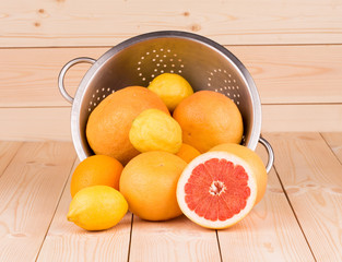 metal colander full of grapefruits.