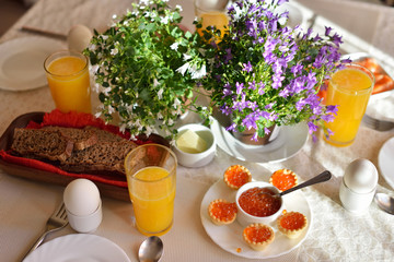 Festive continental breakfast with red caviar, soft-boiled egg a