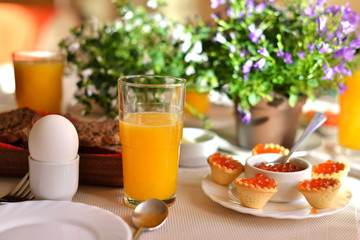 Festive continental breakfast with red caviar, soft-boiled egg a
