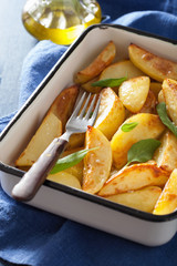 baked potato wedges in enamel baking dish