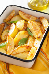 baked potato wedges in enamel baking dish