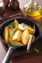 baked potato wedges in black frying pan
