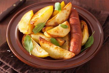 baked potato wedges and sausage in plate over brown rustic table