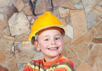 Young constructor with a stone wall of background