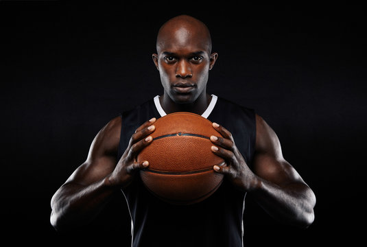 Afro american male basketball player with a ball