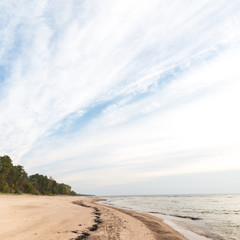 Shoreline of Baltic sea beach with rocks and sand dunes
