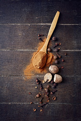Assorted natural spices on wooden background