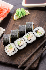 Sushi rolls with eel, cucumber and sesame seed