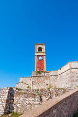 Fototapeta na wymiar The clock tower on the top of the Old Fortress of Corfu. Greece.