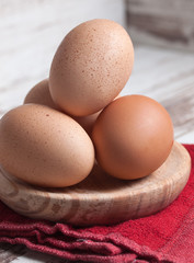 Eggs piled on a wooden plate