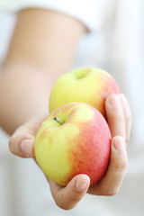 Woman holding apple.