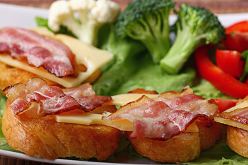 Serving breakfast toast with bacon and herbs