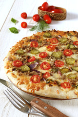American pizza with tomatoes, pickles and minced meat