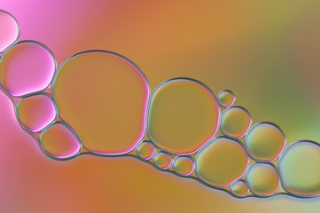colorful drops of oil and air bubbles on the water