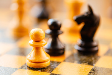 White and black chess pawns and knight standing on chessboard © Great Brut Here