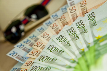 A lot of money, sunglasses and hat. Poker prize, high stake.