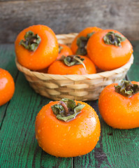 ripe persimmons in a wicker basket