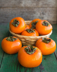 ripe persimmons in a wicker basket