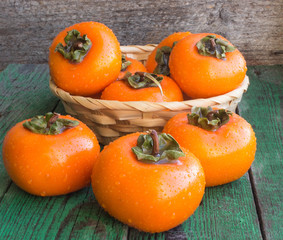 ripe persimmons in a wicker basket