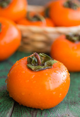 ripe persimmons in a wicker basket