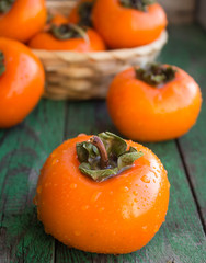 ripe persimmons in a wicker basket